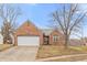 Charming brick home with a two-car garage and a well-manicured front lawn at 10156 Park Royale Dr, Indianapolis, IN 46229