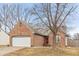 Charming brick home with a two-car garage and a well-manicured front lawn at 10156 Park Royale Dr, Indianapolis, IN 46229