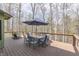 A view of a wooden deck with a table, chairs, and railing showcasing an outdoor seating area at 1032 E Woodall Ct, Martinsville, IN 46151