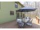 A wooden deck with a table and chairs, offering an inviting outdoor space for relaxation and entertainment at 1032 E Woodall Ct, Martinsville, IN 46151