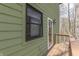 A small wooden deck area with a glass-paned door and window on an exterior wall at 1032 E Woodall Ct, Martinsville, IN 46151