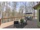 Wooden deck featuring outdoor seating, a table, and railings overlooking scenic greenery and landscaping at 1032 E Woodall Ct, Martinsville, IN 46151