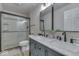 Bathroom featuring double sink vanity, a glass enclosed shower and modern fixtures at 1032 E Woodall Ct, Martinsville, IN 46151