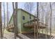 Exterior view showcasing a spacious deck, perfect for relaxation, amidst a backdrop of tall trees at 1032 E Woodall Ct, Martinsville, IN 46151