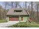 A rustic garage with a loft, featuring an automatic roll-up door at 1032 E Woodall Ct, Martinsville, IN 46151