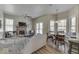 A living room with a fireplace, dining room table and breakfast nook with large bright windows at 1032 E Woodall Ct, Martinsville, IN 46151