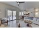 Open-concept living room featuring access to an outdoor patio and views of the kitchen at 1032 E Woodall Ct, Martinsville, IN 46151