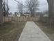 Landscaped backyard with a long walkway, perfect for outdoor enjoyment and gardening at 1038 W 33Rd St, Indianapolis, IN 46208