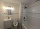 Bathroom with shower and tub with white and blue shower curtain, vanity with sink, and toilet at 1038 W 33Rd St, Indianapolis, IN 46208