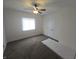 Bedroom featuring ceiling fan, window, and carpet flooring at 1038 W 33Rd St, Indianapolis, IN 46208