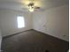 Bedroom boasts a ceiling fan, bright light, and neutral carpeting at 1038 W 33Rd St, Indianapolis, IN 46208