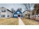 Inviting two-story home with a vibrant blue exterior, a welcoming red door and quaint front porch at 1038 W 33Rd St, Indianapolis, IN 46208