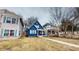 A charming blue two-story home featuring a cozy front porch and well-maintained lawn at 1038 W 33Rd St, Indianapolis, IN 46208