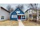 Charming two-story blue home with white trim, red door and a cozy front porch at 1038 W 33Rd St, Indianapolis, IN 46208