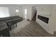 Bright living area featuring a gray sectional, fireplace, and modern flooring at 1038 W 33Rd St, Indianapolis, IN 46208