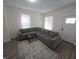 Inviting living room with a gray sectional sofa, dark wood-look flooring, and neutral decor at 1038 W 33Rd St, Indianapolis, IN 46208