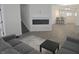 Spacious living area featuring a fireplace, gray sectional sofa and view into the kitchen at 1038 W 33Rd St, Indianapolis, IN 46208