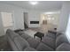 Open concept living room with fireplace, gray sectional sofa, and view into dining area at 1038 W 33Rd St, Indianapolis, IN 46208