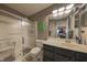 A well-lit bathroom featuring a glass-enclosed shower and a sleek, dark vanity with ample storage at 1057 Timber Creek Dr # 1, Carmel, IN 46032