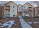 Attractive condo building with brick accents and inviting red door at 1057 Timber Creek Dr # 1, Carmel, IN 46032