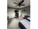 Cozy bedroom includes a ceiling fan, closet, and dedicated gaming/computer space at 1130 W State Road 42, Mooresville, IN 46158
