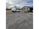 View of the cracked blacktop driveway, garage, and boat, and car at 1130 W State Road 42, Mooresville, IN 46158