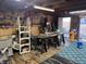 Well-equipped garage featuring multiple work benches, various tools, overhead lighting, and organized storage solutions at 1130 W State Road 42, Mooresville, IN 46158