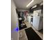 Laundry room including washer, dryer, refrigerator, hanging clothes, and a gray rug at 1130 W State Road 42, Mooresville, IN 46158