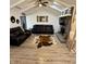 Bright living room with vaulted ceilings, fireplace, and stylish leather sofas offers comfortable living at 1130 W State Road 42, Mooresville, IN 46158