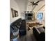 Inviting living room features a decorative brick fireplace, ceiling fan, and cowhide rug at 1130 W State Road 42, Mooresville, IN 46158