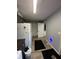A gray mudroom with a white refrigerator along with hooks and cabinet storage at 1130 W State Road 42, Mooresville, IN 46158