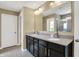 Bathroom featuring a double vanity with granite counters and a large mirror at 14905 W Blackwolf Run Dr, Carmel, IN 46033