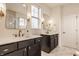 Bathroom featuring double sinks with black cabinets and modern fixtures at 15432 Heatherbank Dr, Westfield, IN 46074