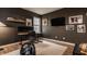 Dark-walled bedroom with a mounted TV, office desk, and decor at 15432 Heatherbank Dr, Westfield, IN 46074