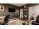 Cozy room with a gaming chair, a mounted TV, and decor on dark walls at 15432 Heatherbank Dr, Westfield, IN 46074