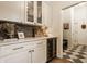 Charming butler's pantry with custom cabinets, wine fridge, and unique tiled flooring at 15432 Heatherbank Dr, Westfield, IN 46074