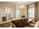 Open dining room featuring a dark wood table, stylish seating, and a view of the staircase at 15432 Heatherbank Dr, Westfield, IN 46074