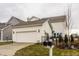 Exterior view of a home with a two-car garage and manicured landscaping at 15432 Heatherbank Dr, Westfield, IN 46074