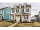 Charming two-story home with covered front porch and colorful siding in a vibrant neighborhood at 15432 Heatherbank Dr, Westfield, IN 46074