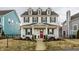 Charming two-story home boasts a welcoming front porch, a vibrant red front door, and well-manicured landscaping at 15432 Heatherbank Dr, Westfield, IN 46074