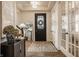 Bright foyer with decorative rug, glass paneled door, and view of the staircase at 15432 Heatherbank Dr, Westfield, IN 46074