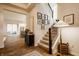 Welcoming foyer with staircase, picture frames, and view into the modern kitchen at 15432 Heatherbank Dr, Westfield, IN 46074