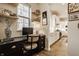Stylish home office area featuring a black desk, window, and shelves, adjacent to the modern, bright kitchen at 15432 Heatherbank Dr, Westfield, IN 46074
