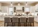 Bright kitchen with quartz countertops, island seating, and modern pendant lighting at 15432 Heatherbank Dr, Westfield, IN 46074