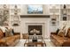 Elegant living room showcasing a fireplace, custom shelving, and comfortable leather sofas at 15432 Heatherbank Dr, Westfield, IN 46074