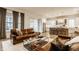 Bright living space features leather sofa, large windows, and seamless flow to the modern kitchen at 15432 Heatherbank Dr, Westfield, IN 46074