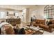 Open-concept living room showcases leather sofas, glass coffee table, and seamless flow to kitchen at 15432 Heatherbank Dr, Westfield, IN 46074