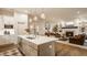 Open-concept kitchen and living room featuring a modern island, fireplace, and ample natural light at 15432 Heatherbank Dr, Westfield, IN 46074