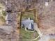 Aerial view showcasing the property's layout within a wooded neighborhood setting at 15921 Herriman Blvd, Noblesville, IN 46060