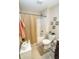 Functional bathroom featuring a shower with curtain, toilet, and neutral tiling, maximizing space at 15921 Herriman Blvd, Noblesville, IN 46060